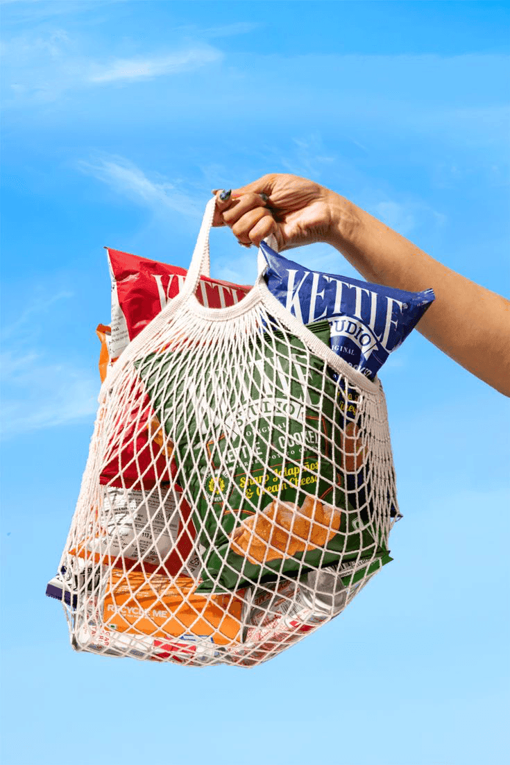 A mesh shopping bag full of fresh produce
